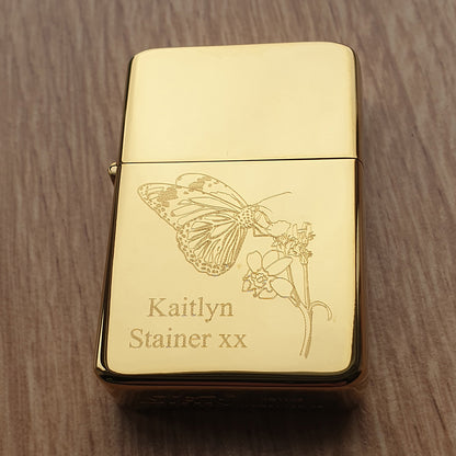 Brass lighter engraved  with butterfly and plant artwork.