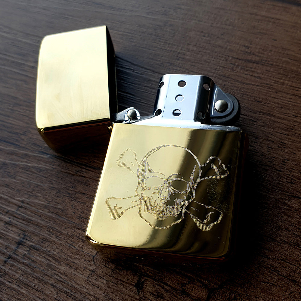 Gold Brass lighter with skull and crossbones design