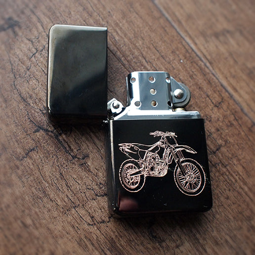 Motocross dirt bike artwork engraved on a black ice lighter