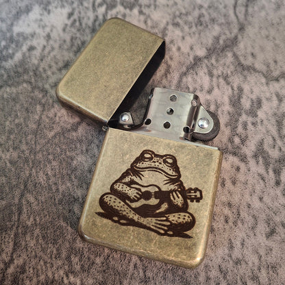 Lighter with Vintage Brass style coating engraved with a Toad and Ucayali