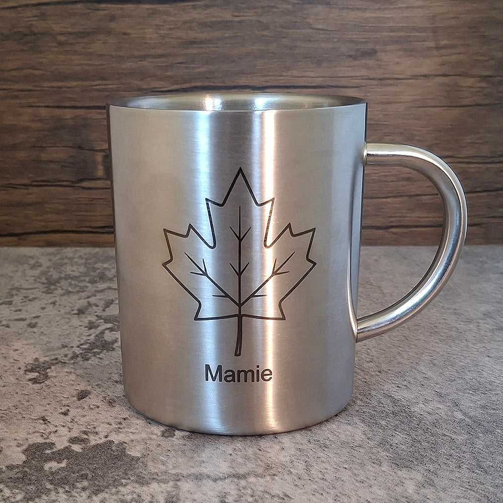 A Brushed Silver camping mug engraved with a name and maple leaf