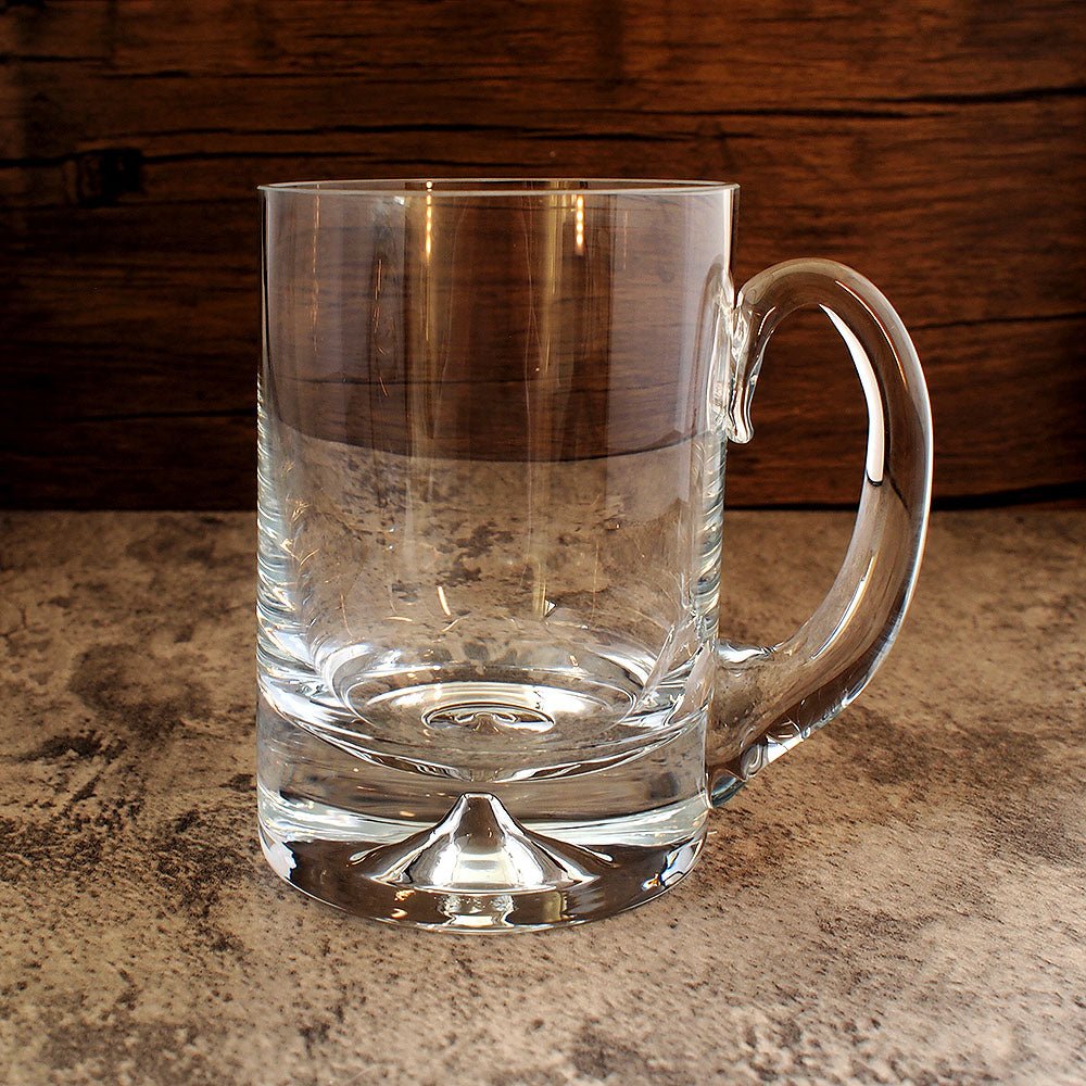hand made dimple base glass tankard with curved handle shown from the front