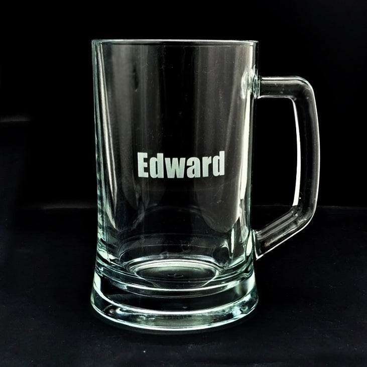 Clear glass mug with 'Edward' engraved on a black background