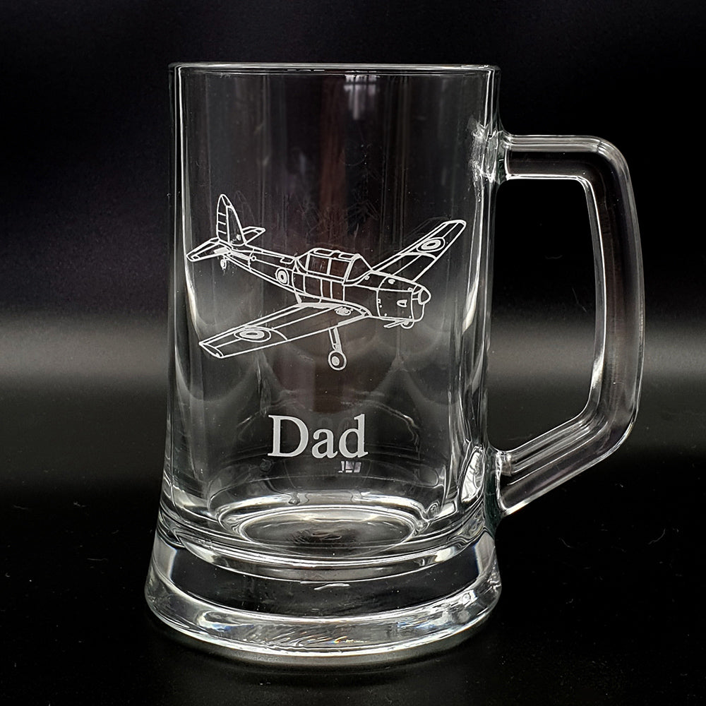 Clear glass mug with vintage chipmunk airplane engraving and 'Dad' text on a black background