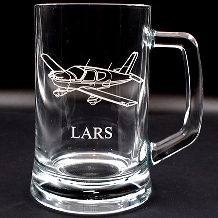 Clear tankard mug with socata TB9 airplane engraving and 'LARS' text on a black background