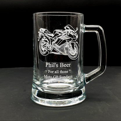 Clear glass mug with  motorcycle engraving and text on a black background