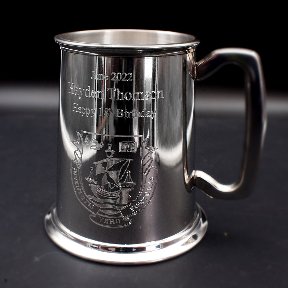 Pewter silver Birthday tankard with text and crest engraved against a black background