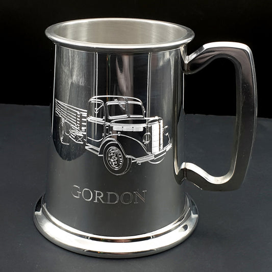Silver mug with engraved vintage truck design and 'GORDON' text on a dark background