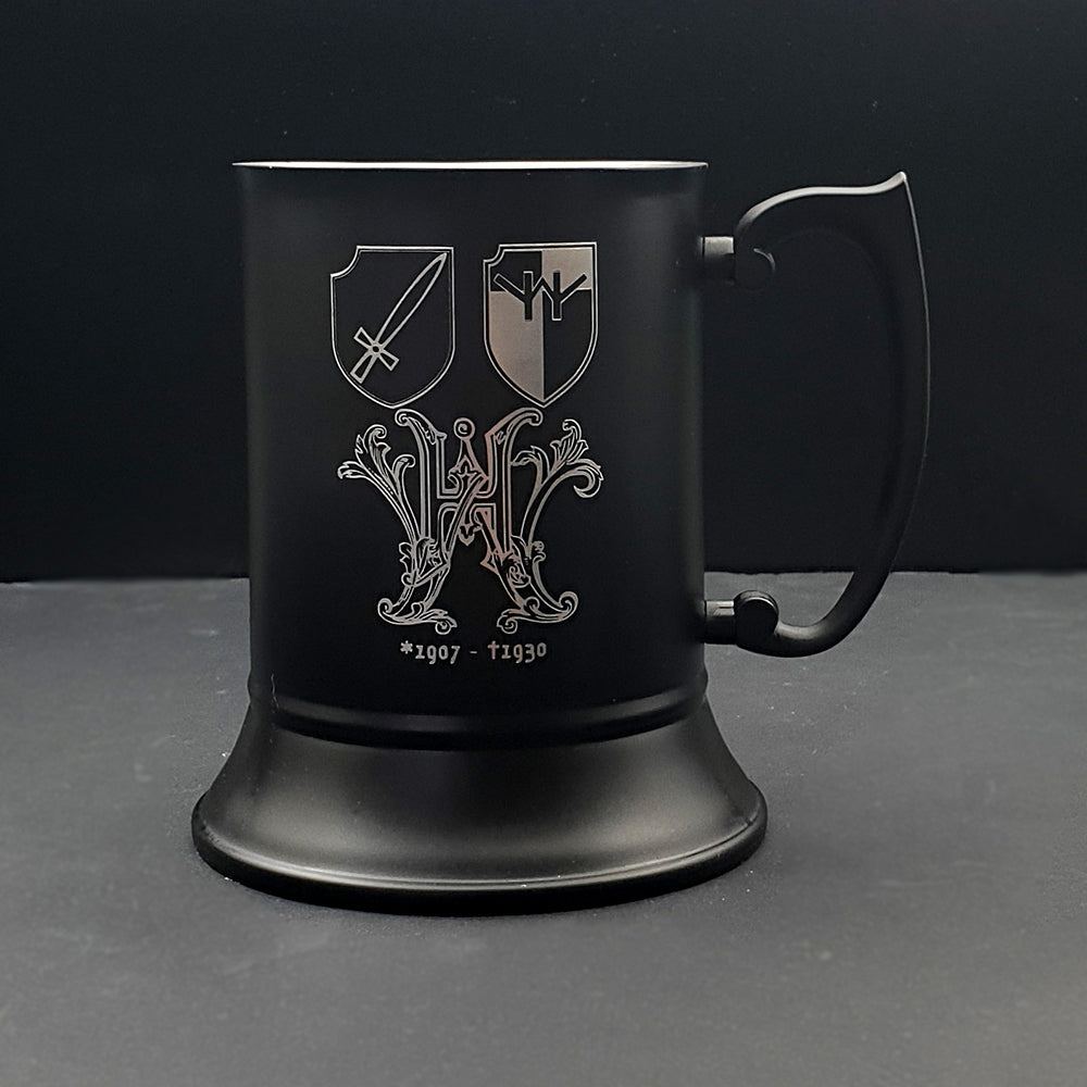 Black steel tankard with an ornate crest and shields engraved.