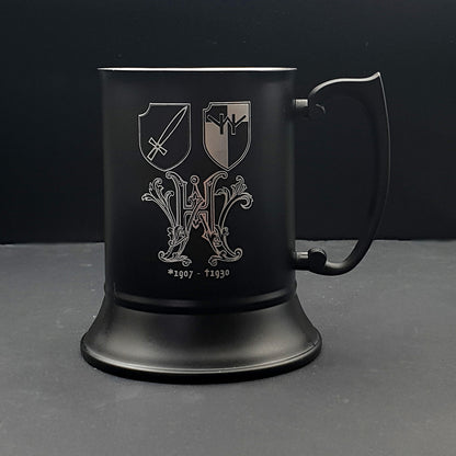 Black steel tankard with an ornate crest and shields engraved.
