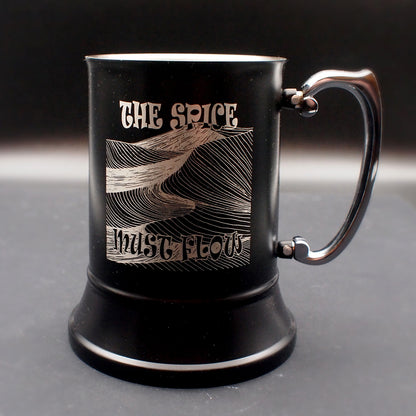 Black mug with engraved design and text on a dark background