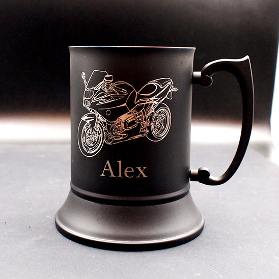 Black mug with R1100 motorcycle engraving and 'Alex' text on a gray surface