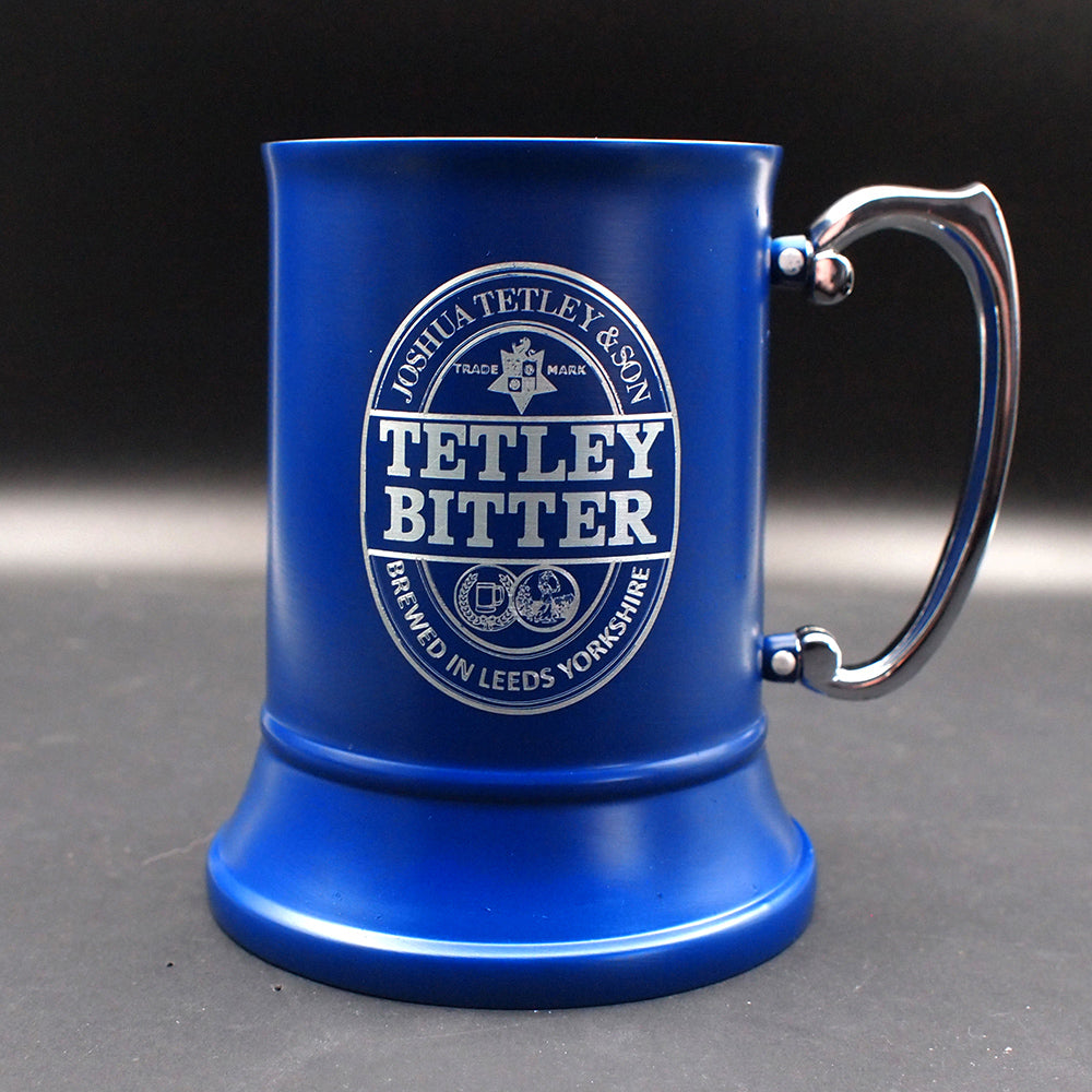 Blue steel mug with Tetley Bitter branding on a dark background