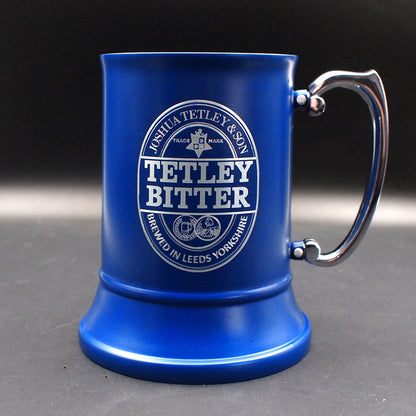 Blue steel mug with Tetley Bitter branding on a dark background