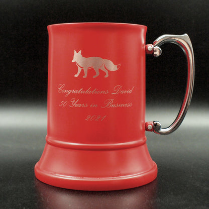 Red mug with engraved text and fox image with silver handle on a dark background