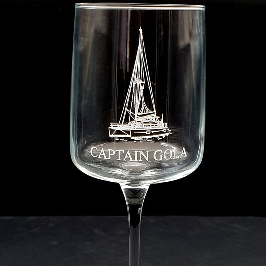 wine glass with a catamaran engraving and 'Captain Gola' text on a black background
