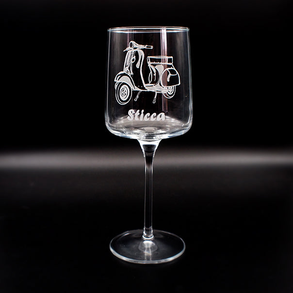 Wine glass with vespa scooter engraving and 'Sticca' text below