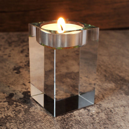 low angle image of optic glass tealight holder with candle