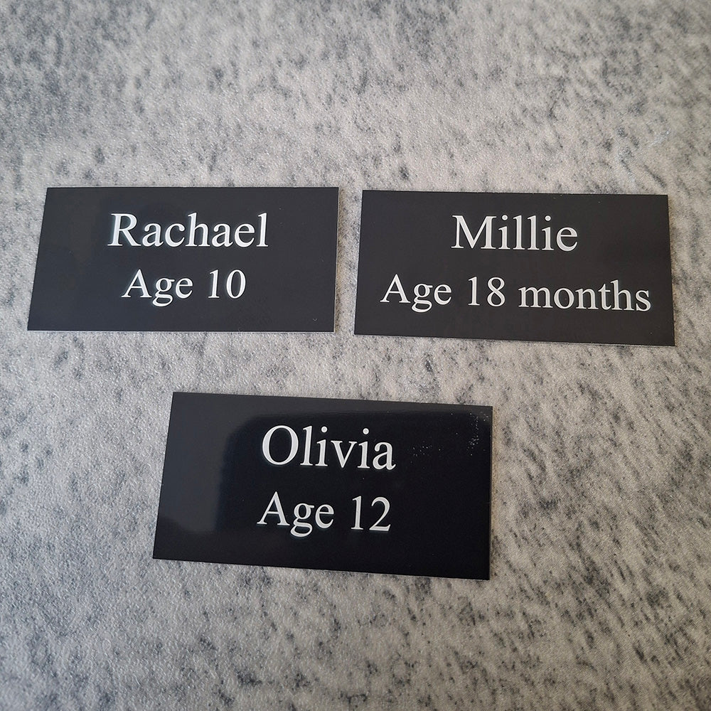 set of 3 black straight corner plaques engraved with baby names and ages