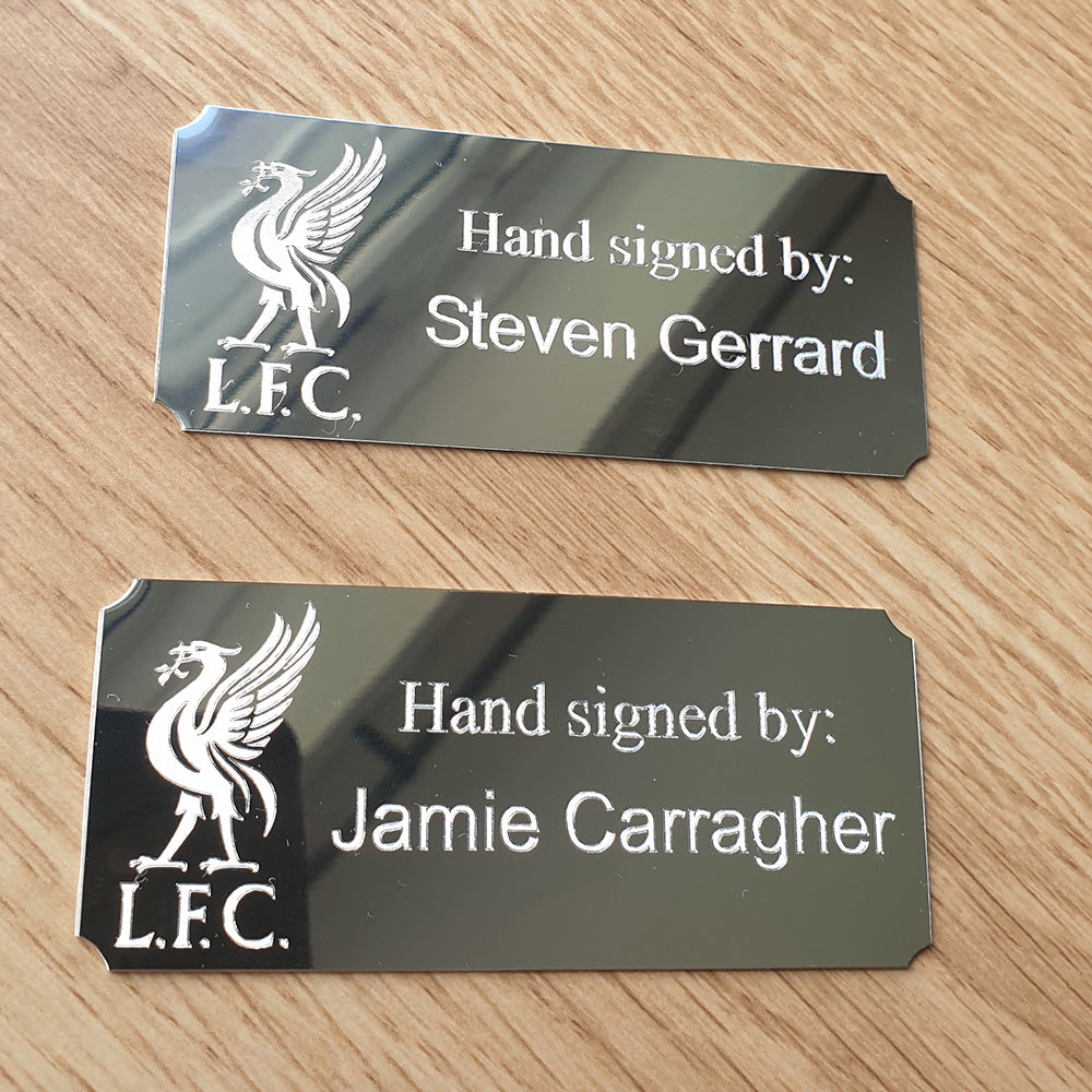 Two Silver plaques with the Liverpool FC logo and names Steven Gerrard and Jamie Carragher.