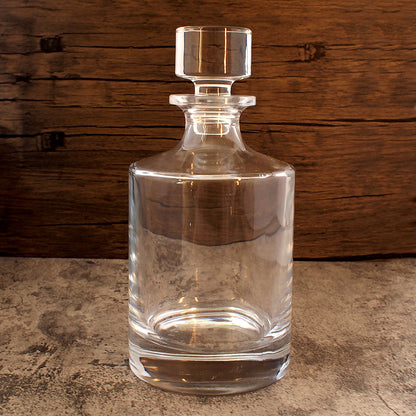 front image of round glass spirits decanter  with stopper in place. 
